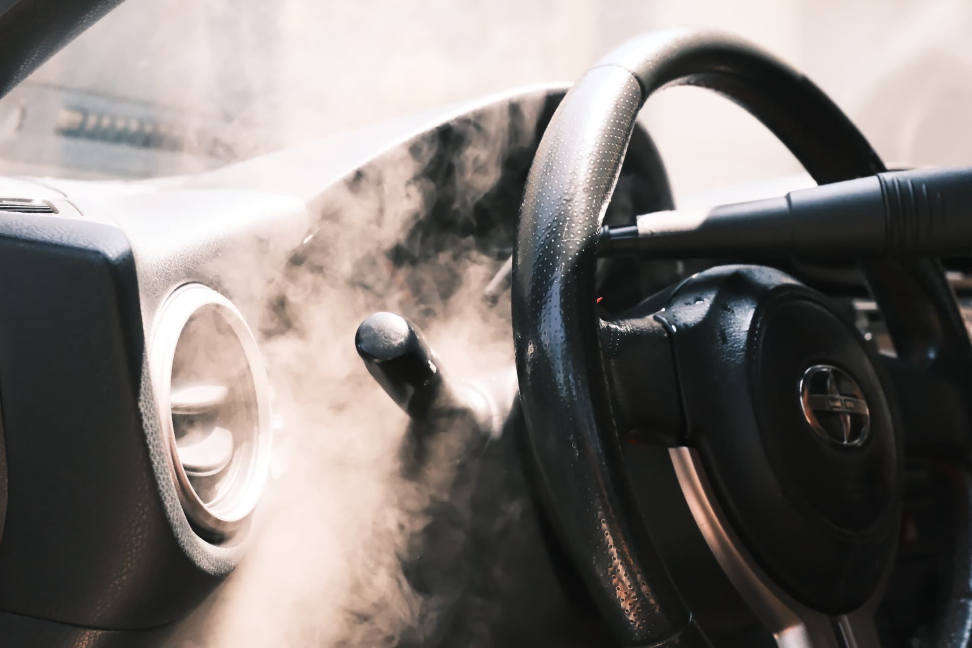 Steam cleaning a steering wheel and dashboard