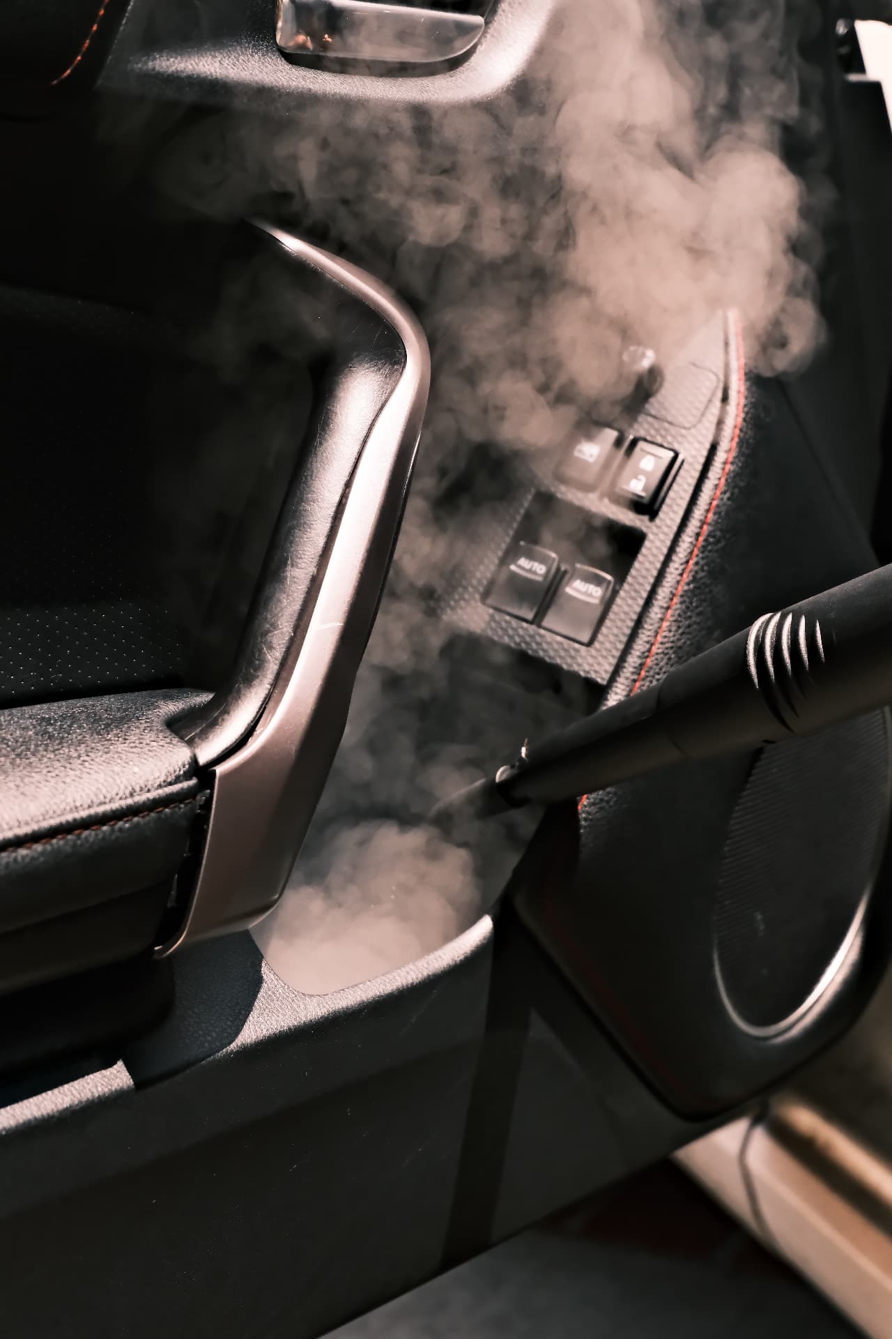 Steam cleaning a car door panel and window controls